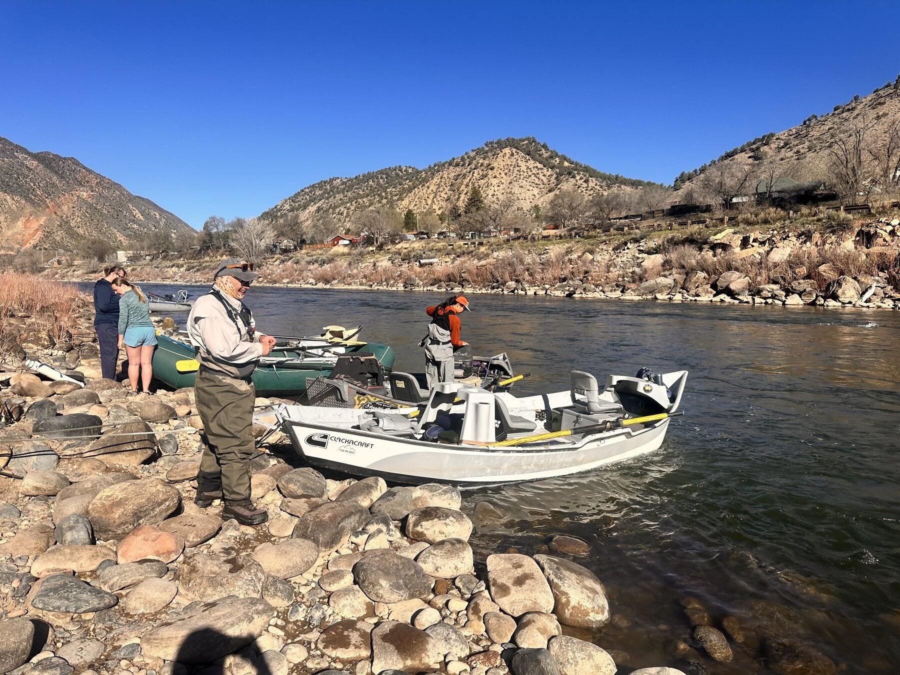 High Plains Drifters anglers preparing drift boats beside a Colorado river